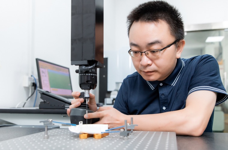 Engineer checking tight tolerances on aluminum car part